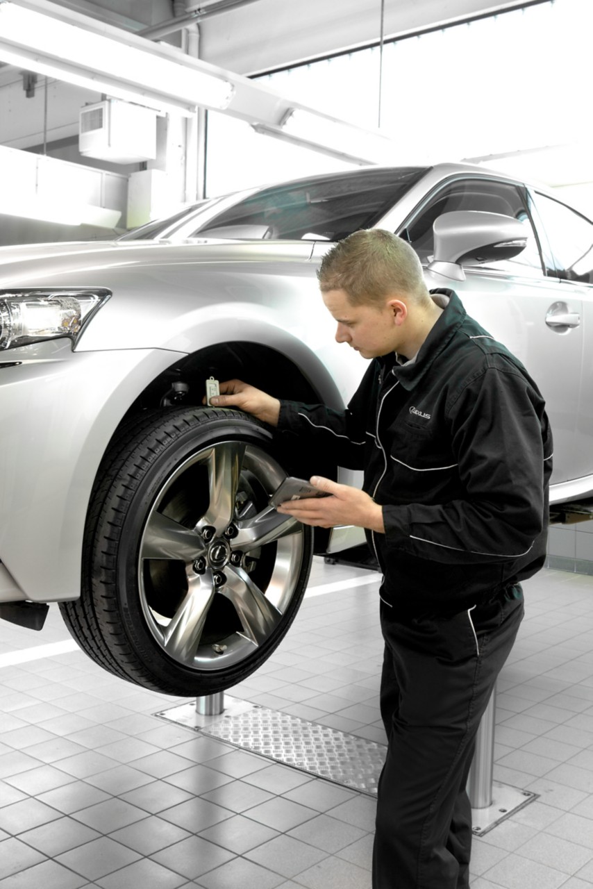 A person inspecting a Lexus vehicle