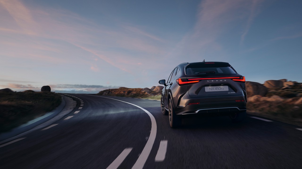 Lexus NX 450h+ driving on a rural road 