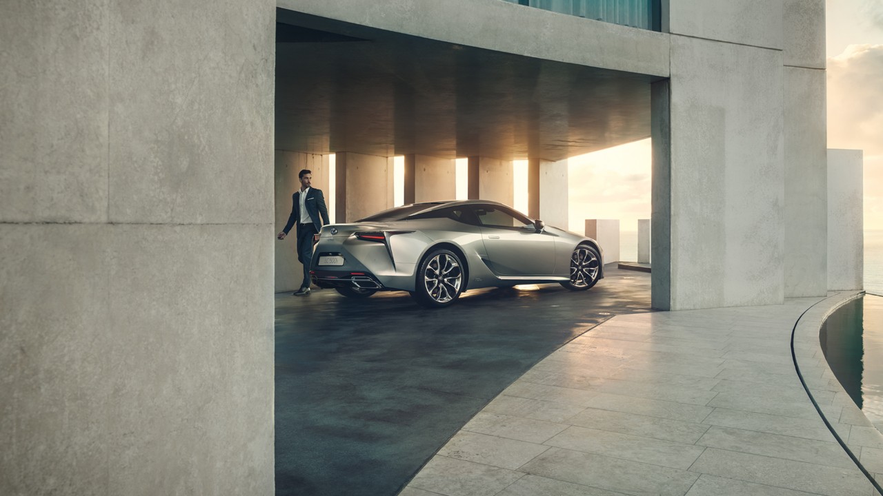 A man walking away from a Lexus LC 