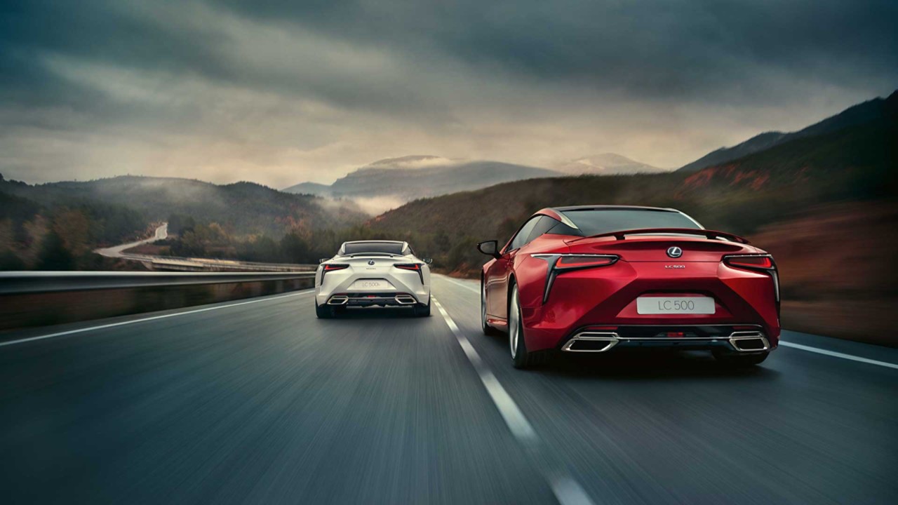 A Lexus LC 500 and Lexus LC 500h driving on a road