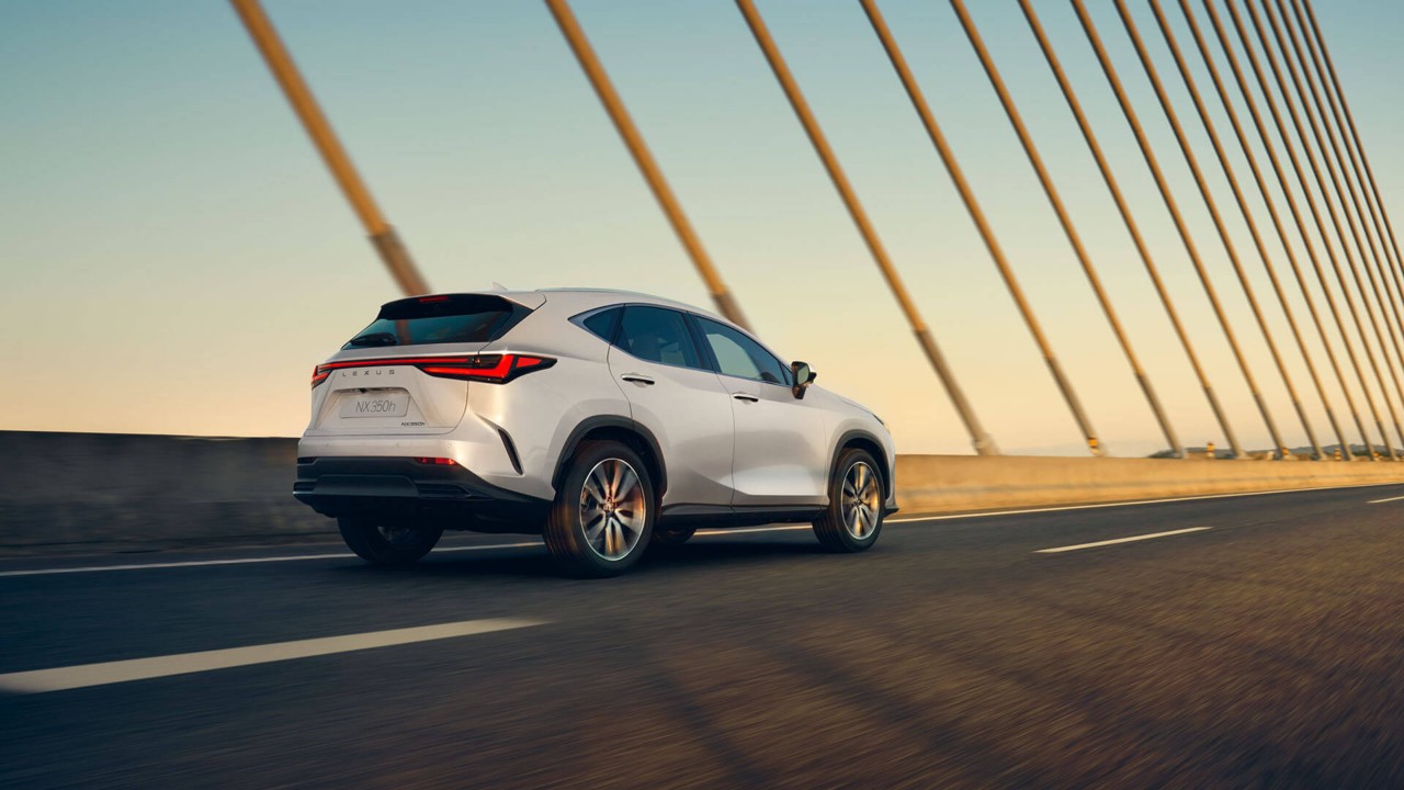 Lexus NX 350h driving across a bridge 