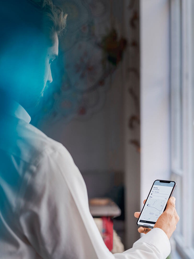 A man using his mobile phone to access the Lexus Link app