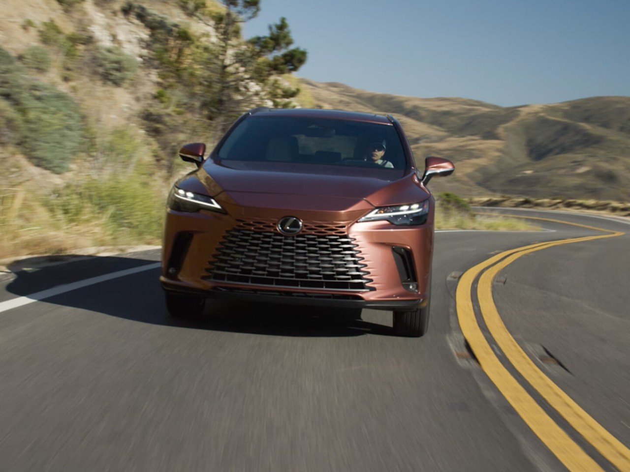 The Lexus RZ driving on a road