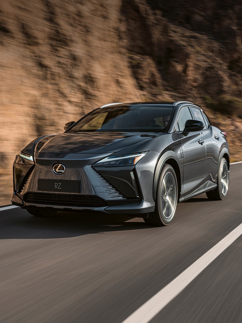 A Lexus UX 300e plugged into a charging tower