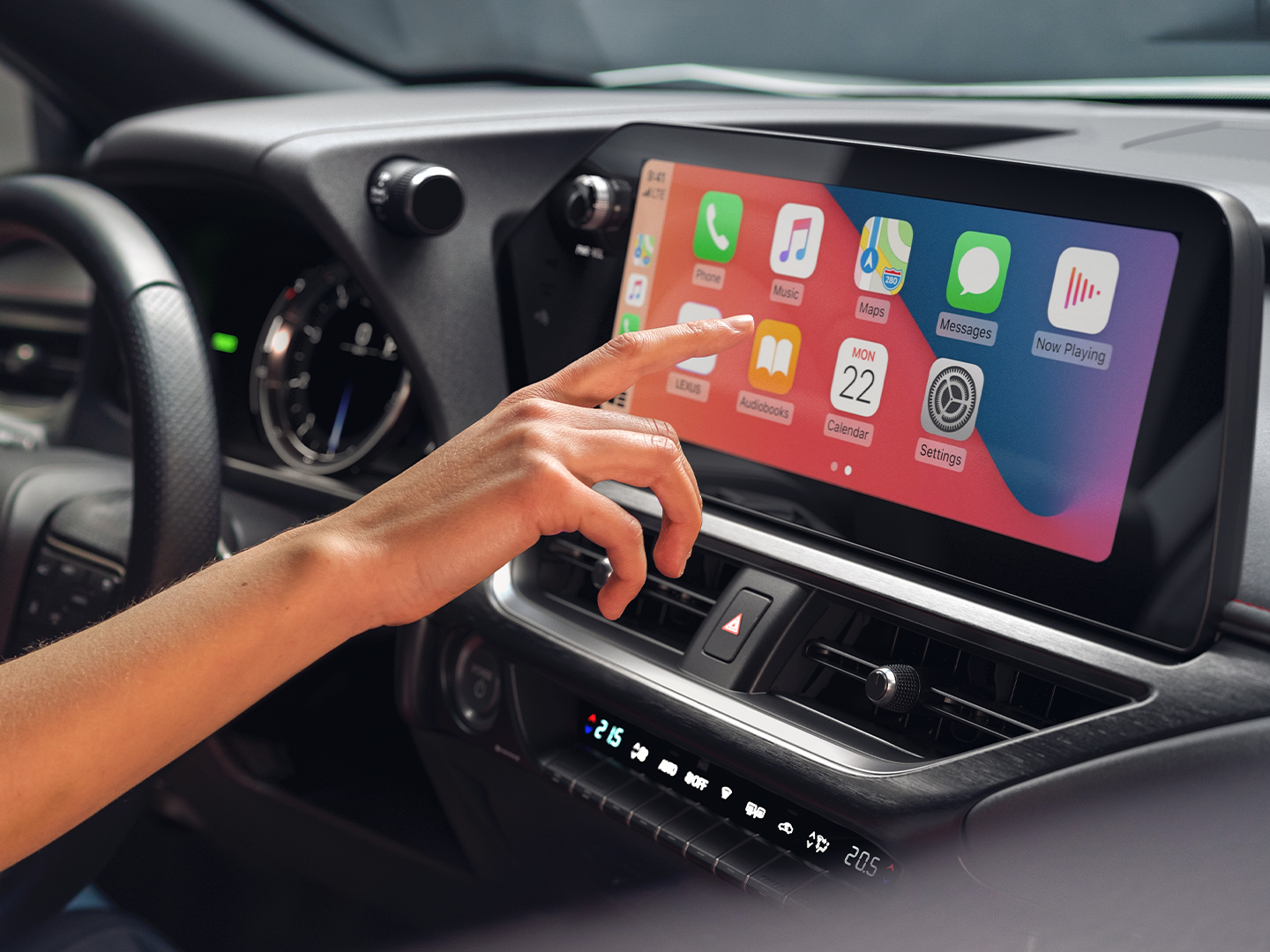 A person using the touchscreen in the Lexus UX