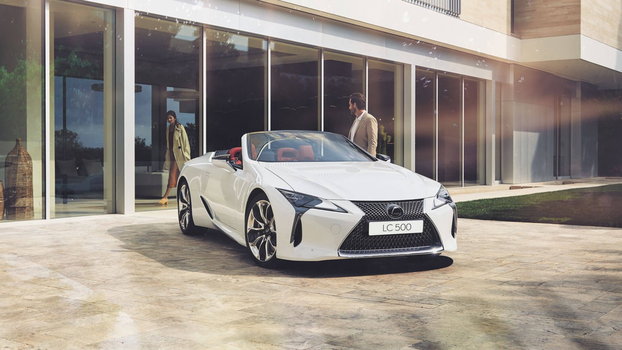 A man standing next to a Lexus LC Convertible