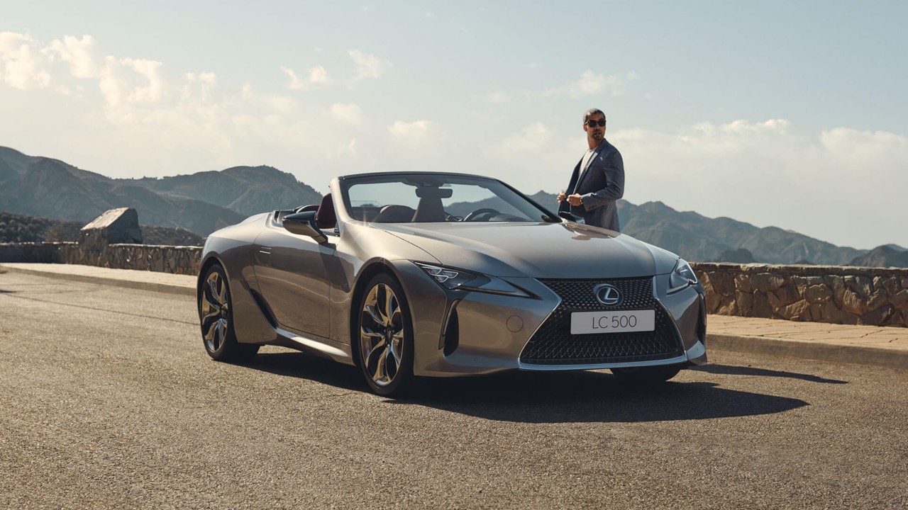 A man standing next to a Lexus LC Convertible