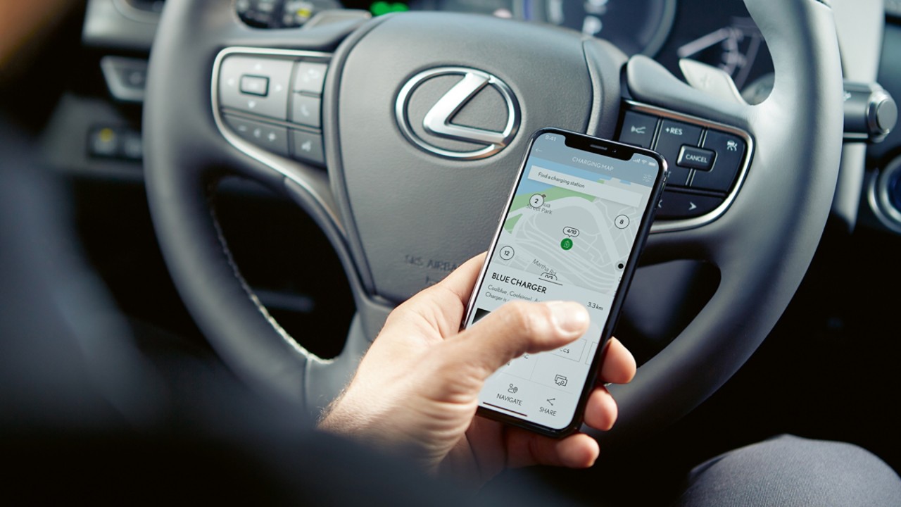 A person using a mobile phone to access the Lexus Link app