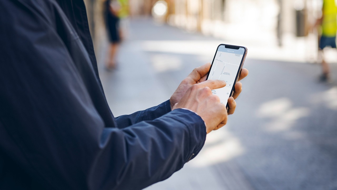 A man using his mobile phone to access the Lexus Link app