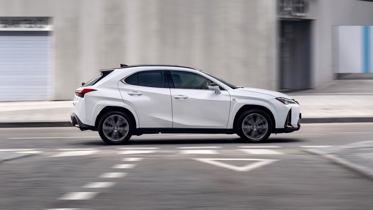 Side view of the Lexus UX driving on a road