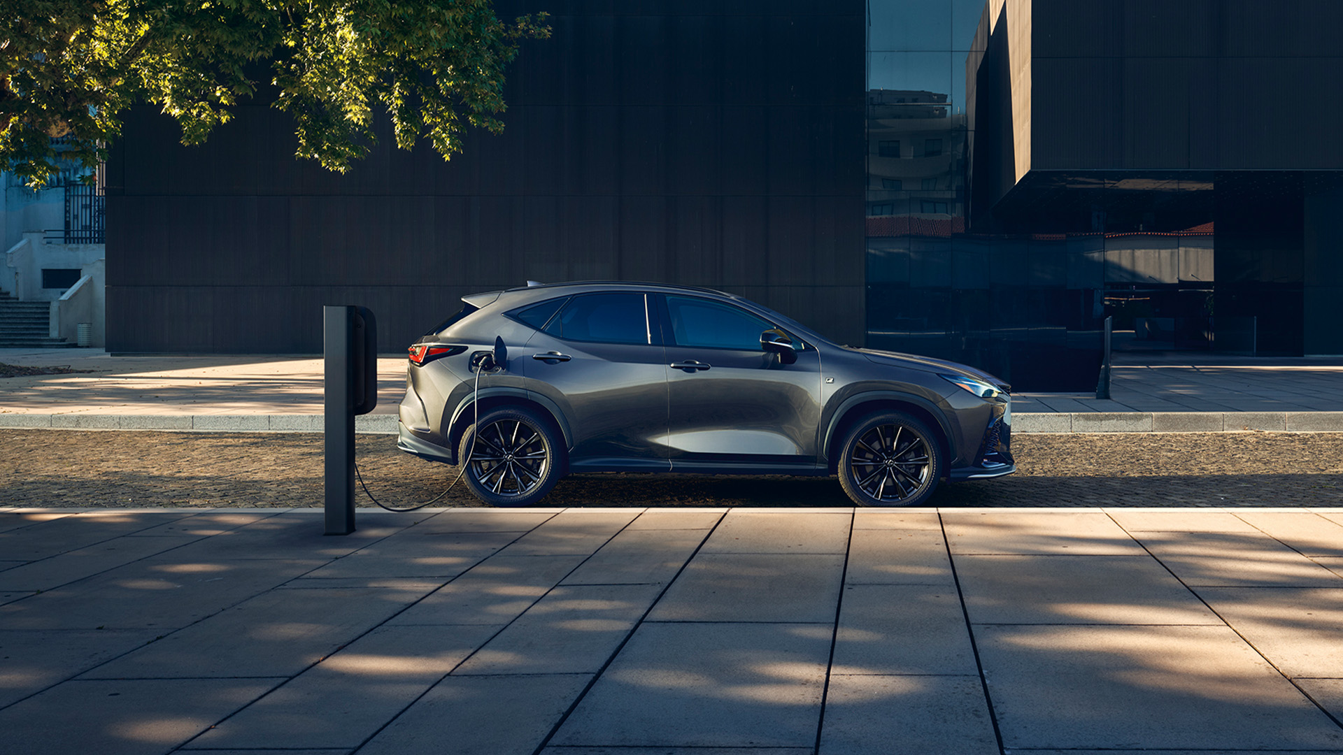 Lexus NX plugged into a charging tower