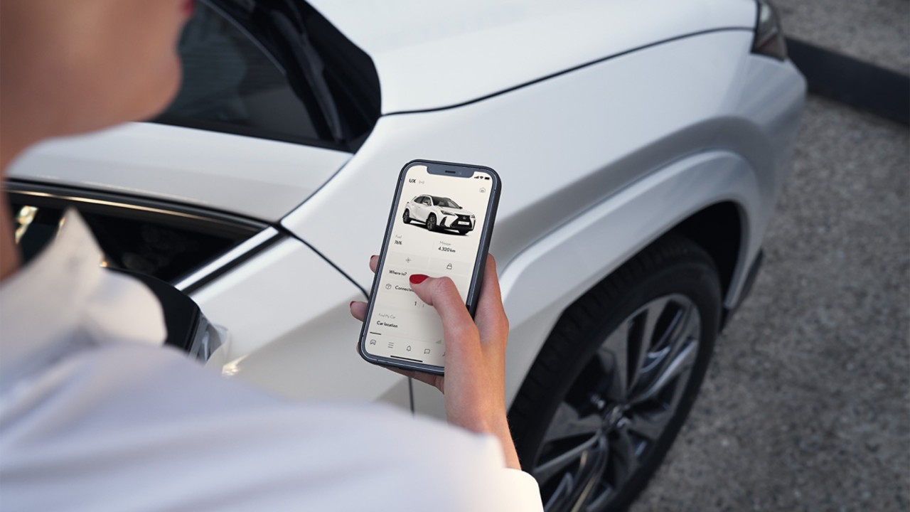 A woman using a mobile phone to access the Lexus Link app